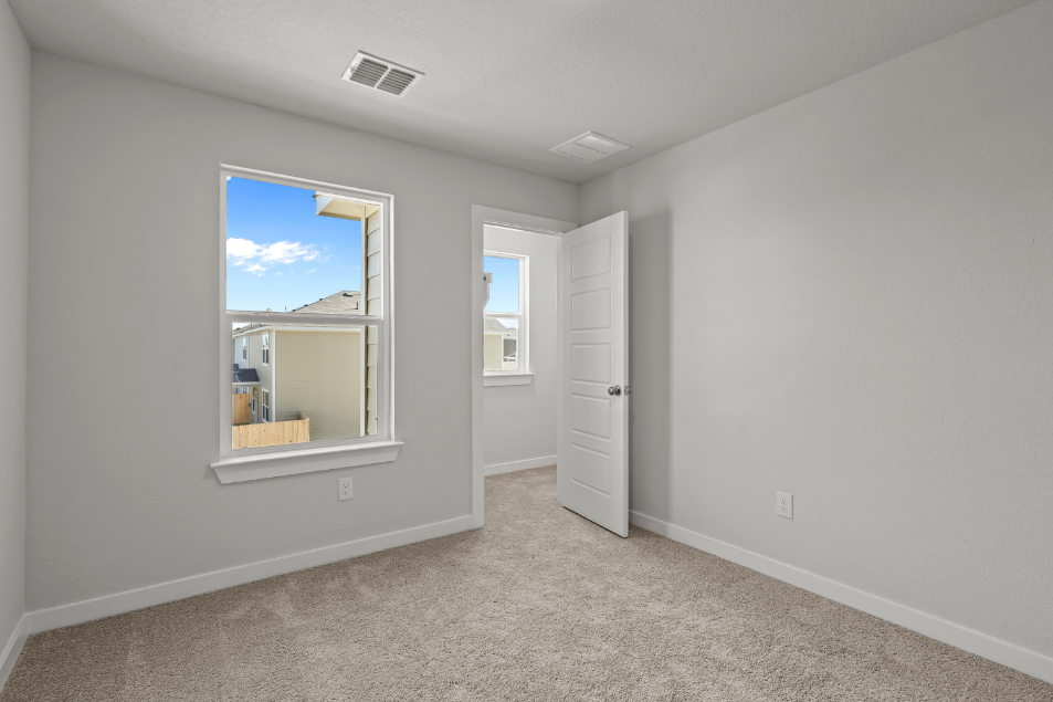 A room with a mirror and a door.