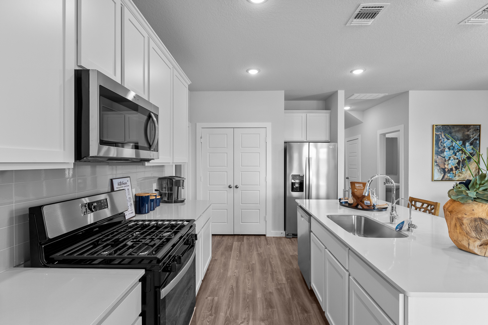 A kitchen with white cabinets.