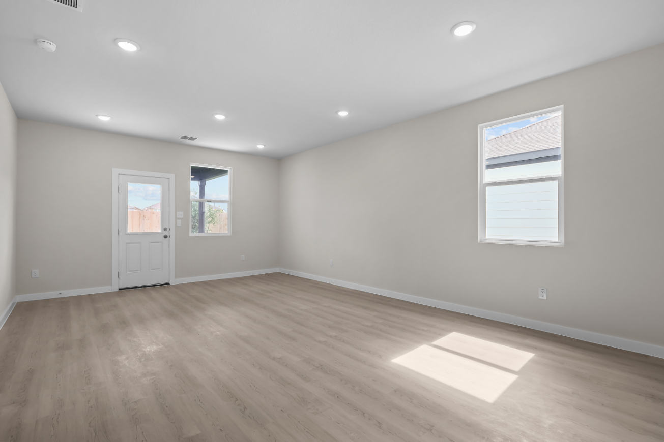 A room with a wood floor and a white door.