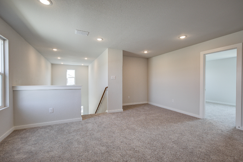 A room with a ladder and a door.