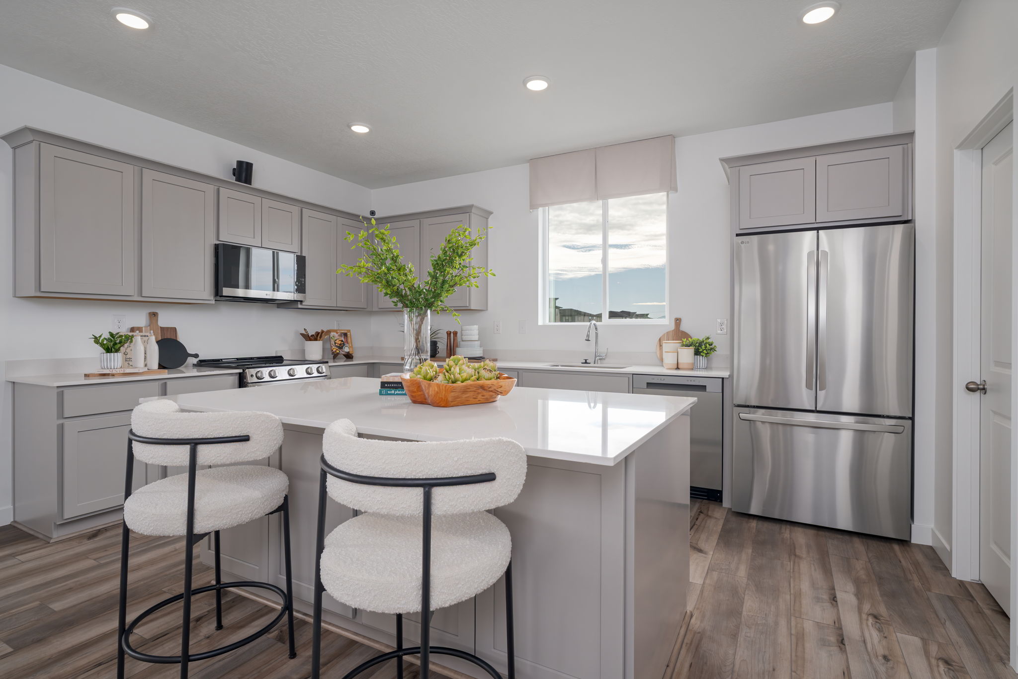 A kitchen with white cabinets.