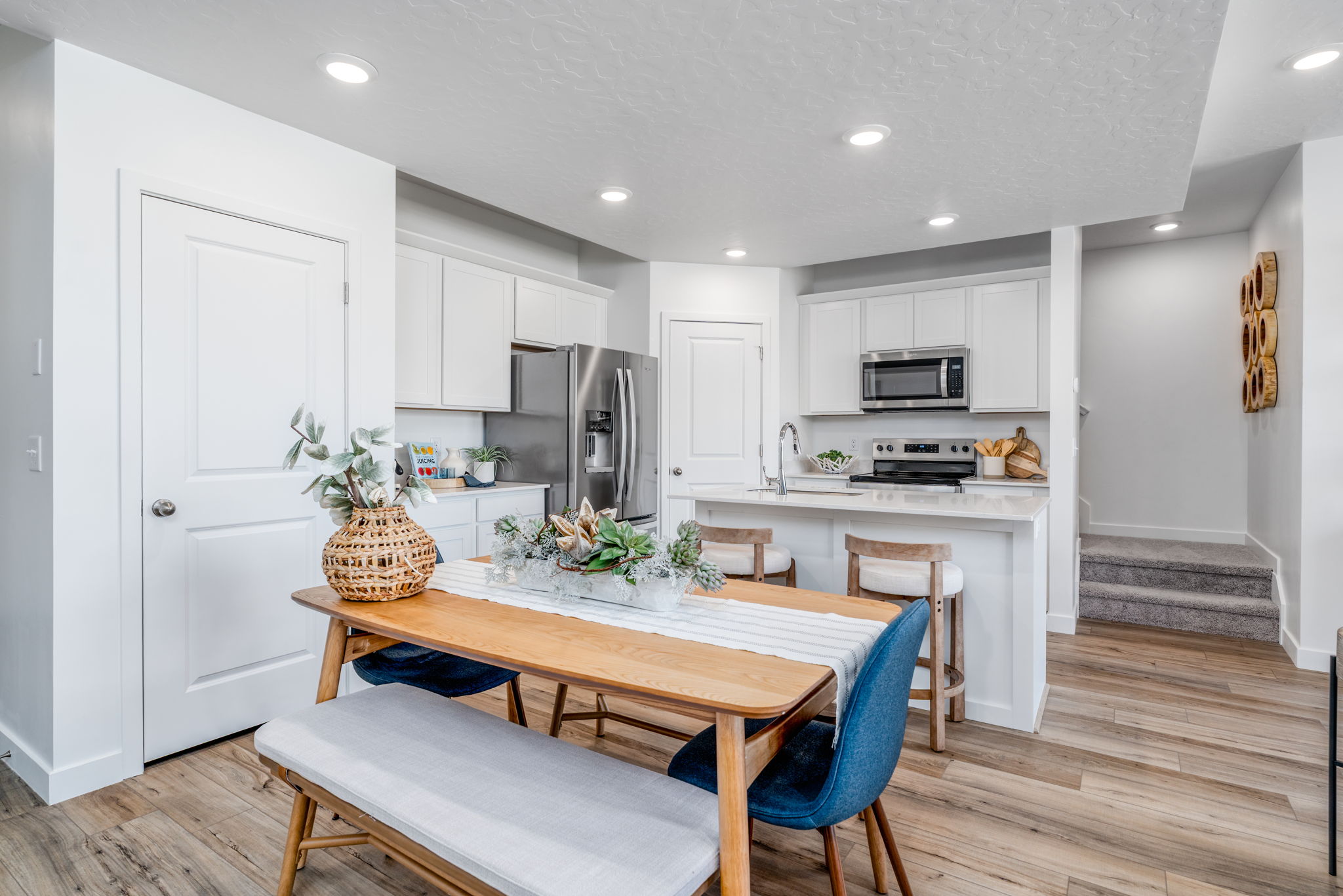A kitchen with a table and chairs.