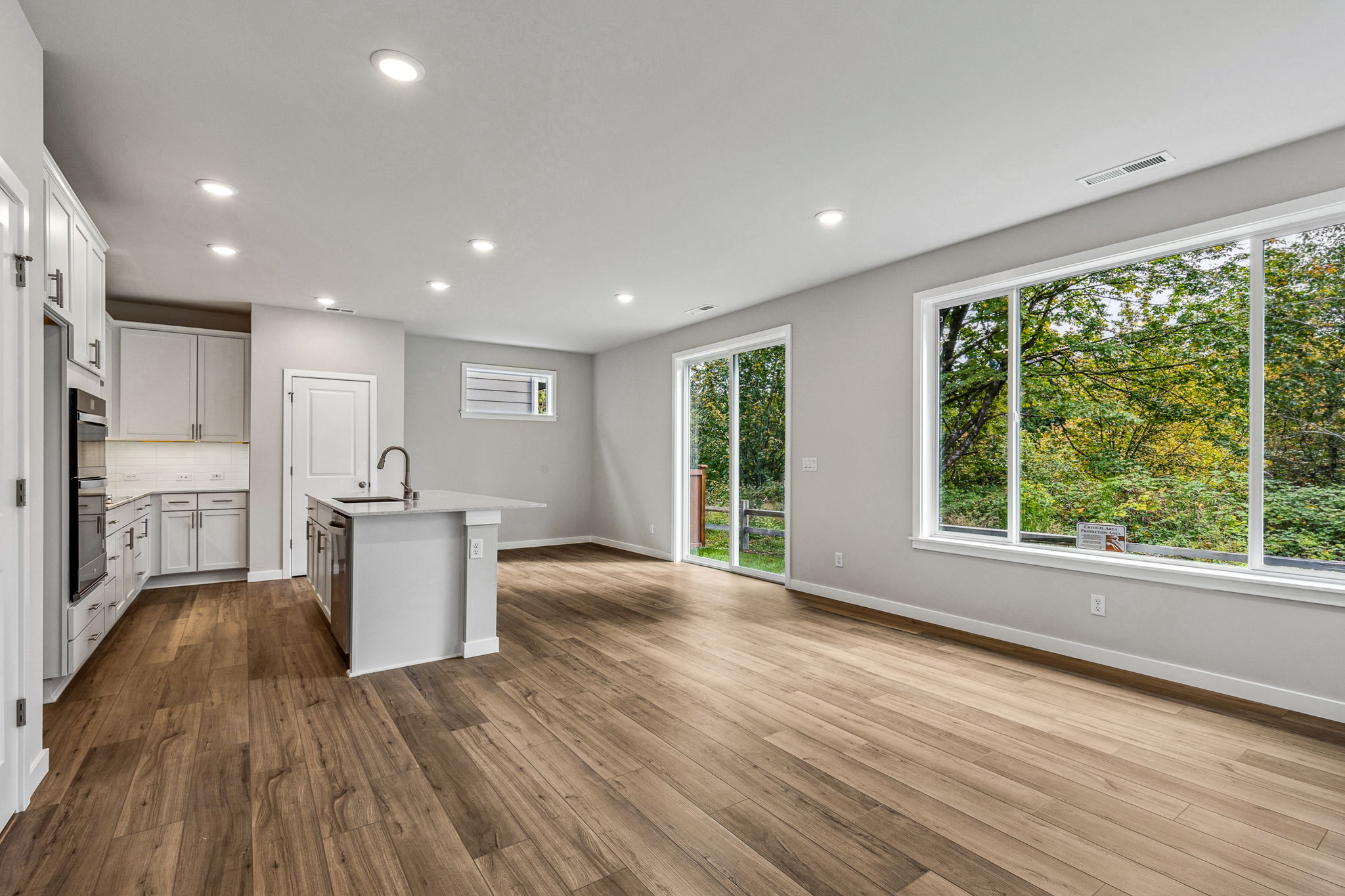 A kitchen with a wood floor.
