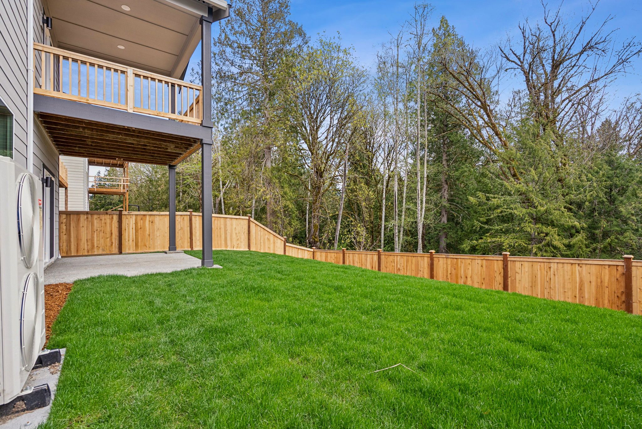 A backyard with a fence and trees.