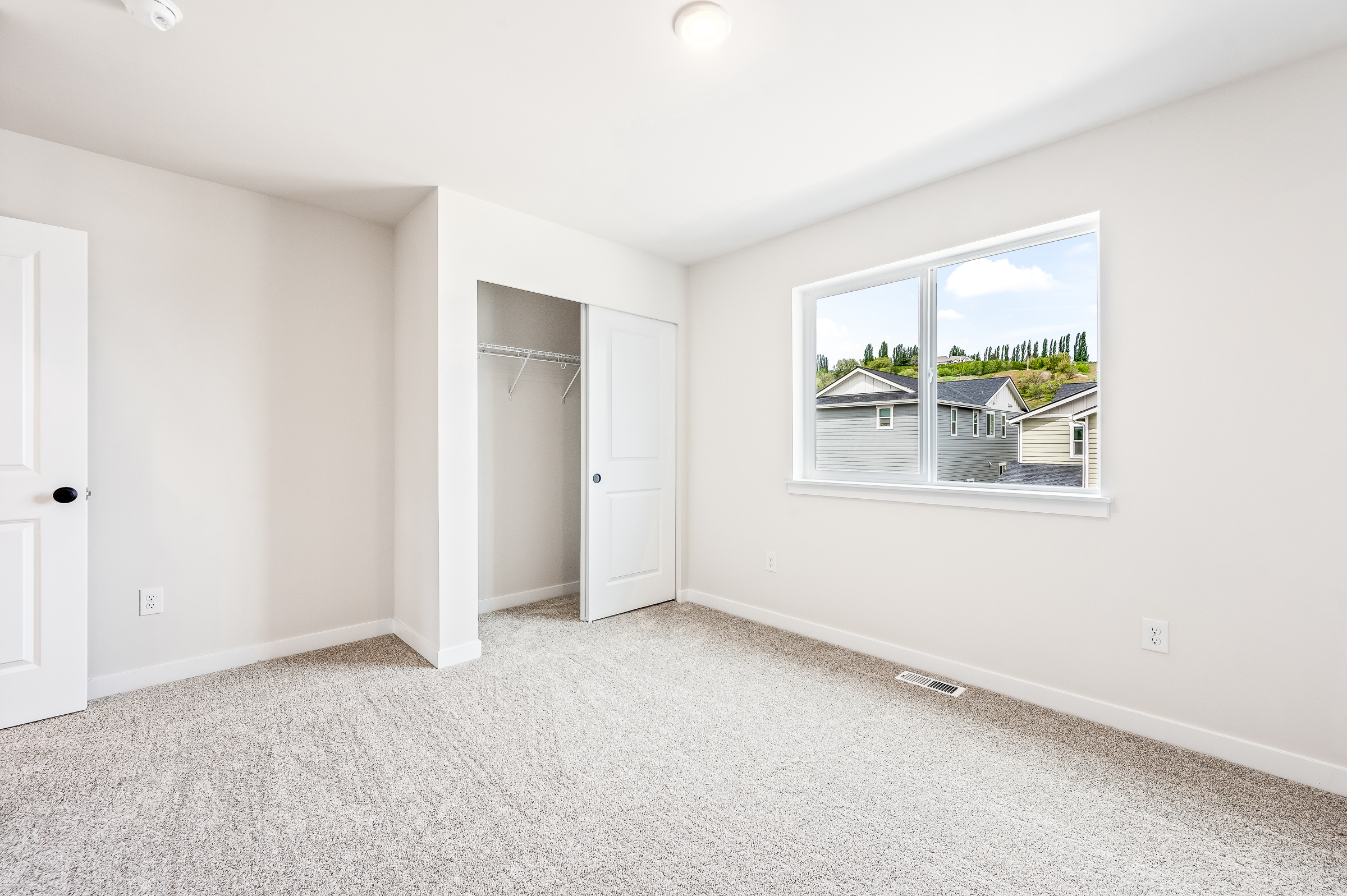 A room with a window and a door.