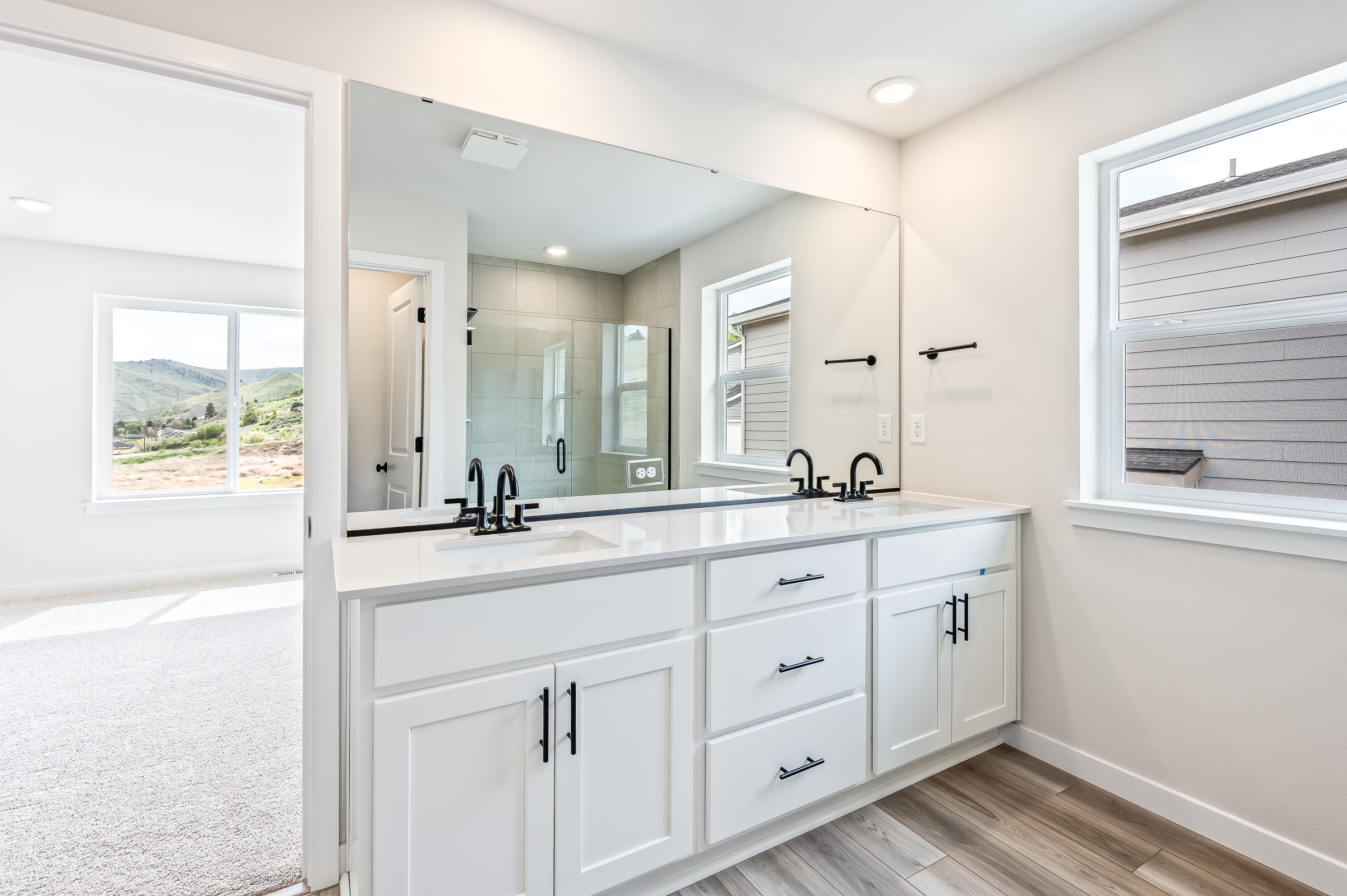 A bathroom with white cabinets.