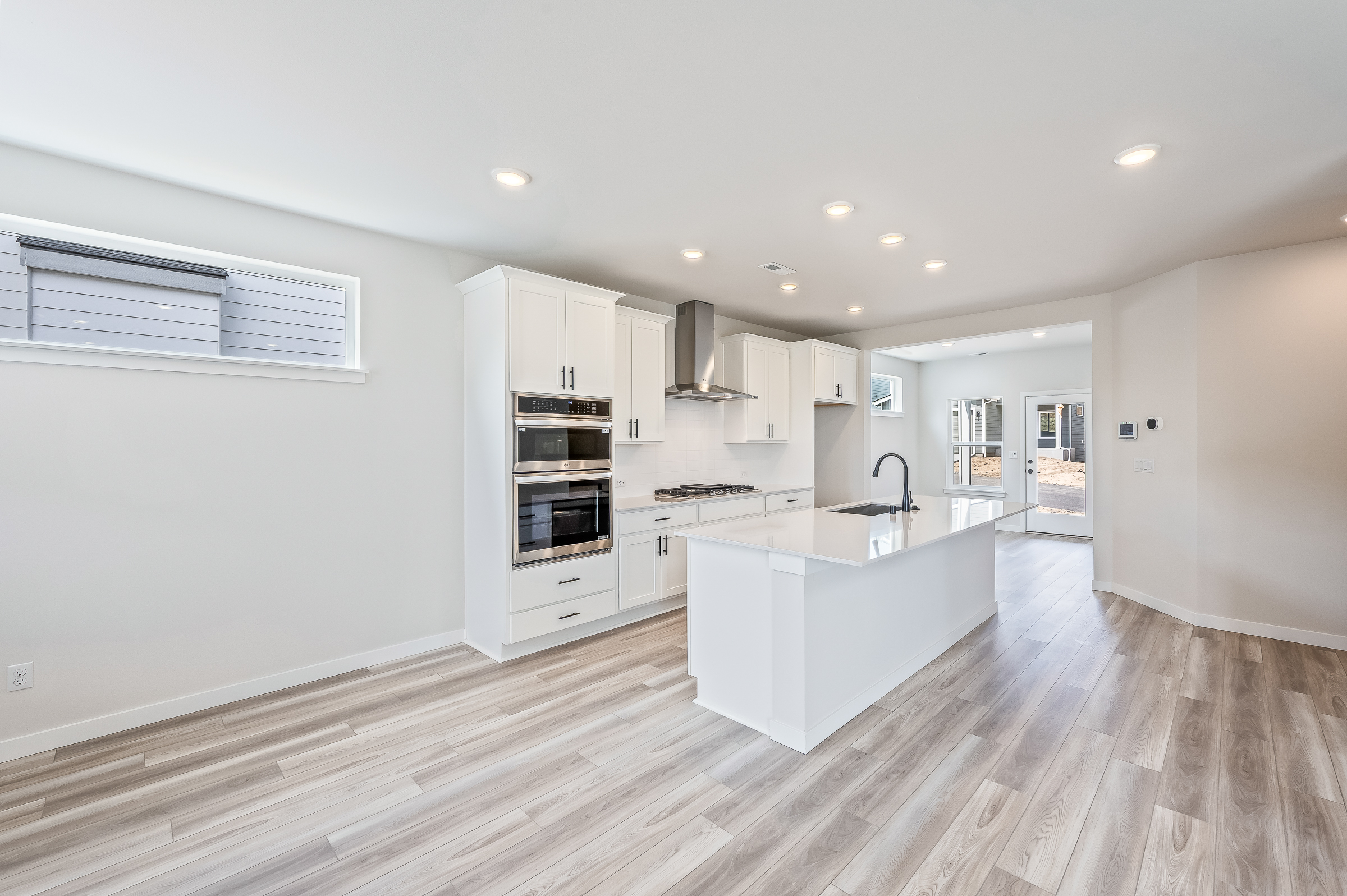 A kitchen with white cabinets.