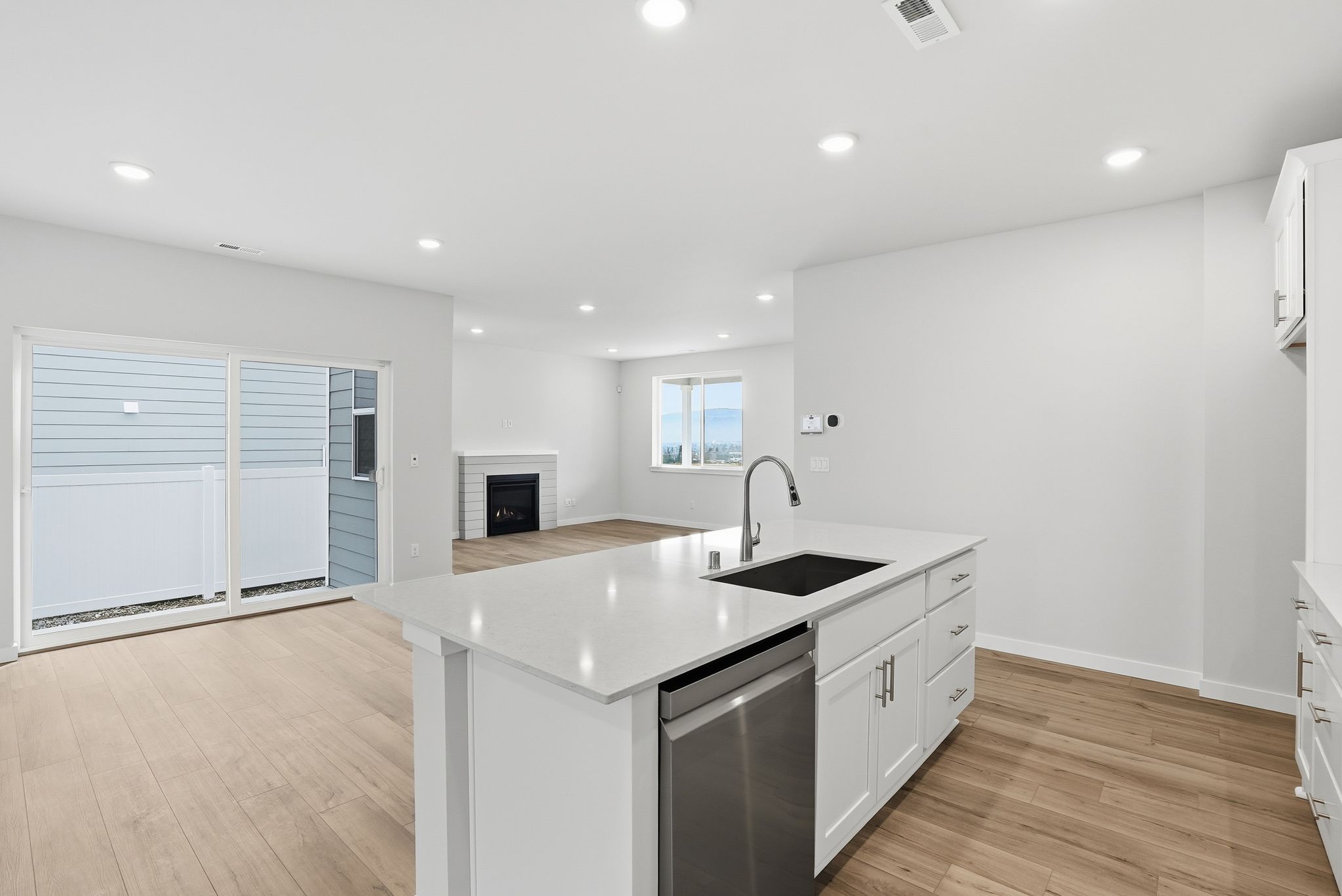 A kitchen with white cabinets.