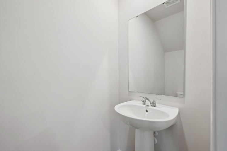 A bathroom with a large mirror.