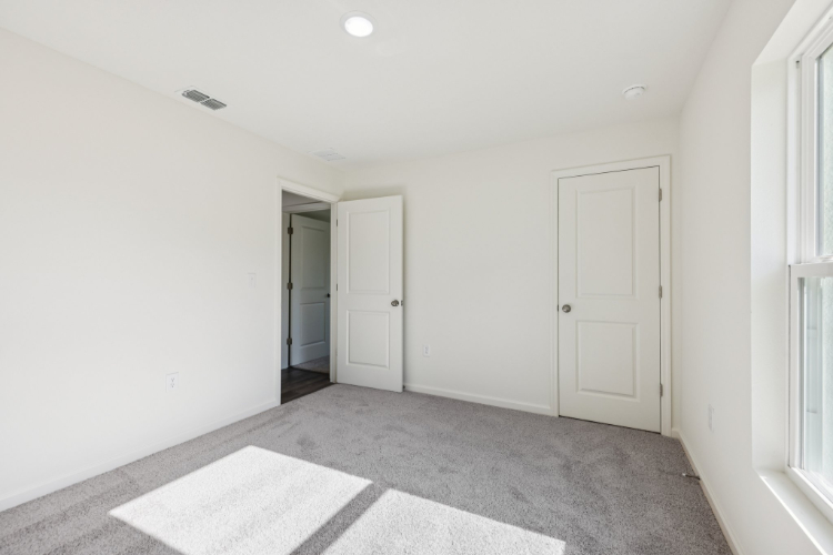A hallway with white doors.