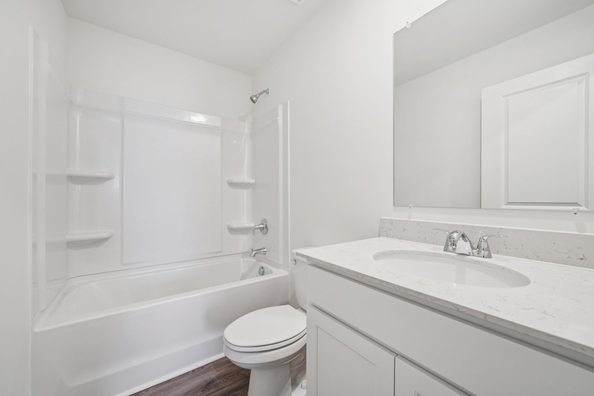 A bathroom with a tub sink and toilet.