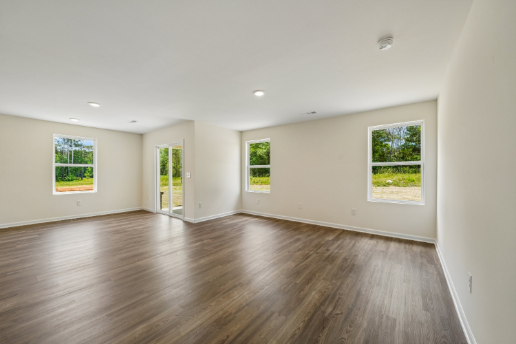 A room with windows and wood floors.