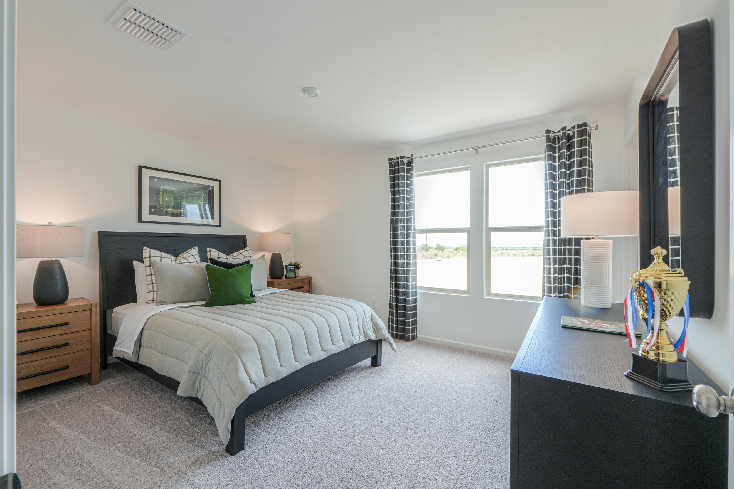 A bedroom with a bed and a tv.