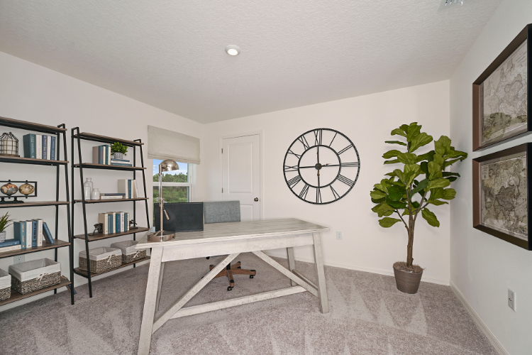 A living room with a white table and a clock.