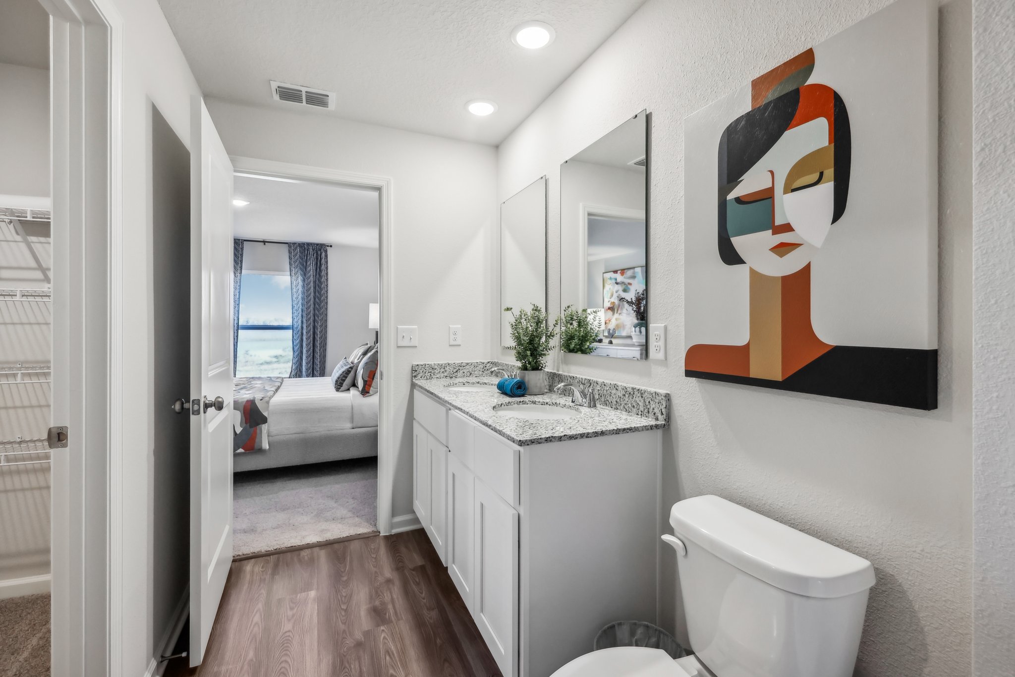 A bathroom with a large mirror.