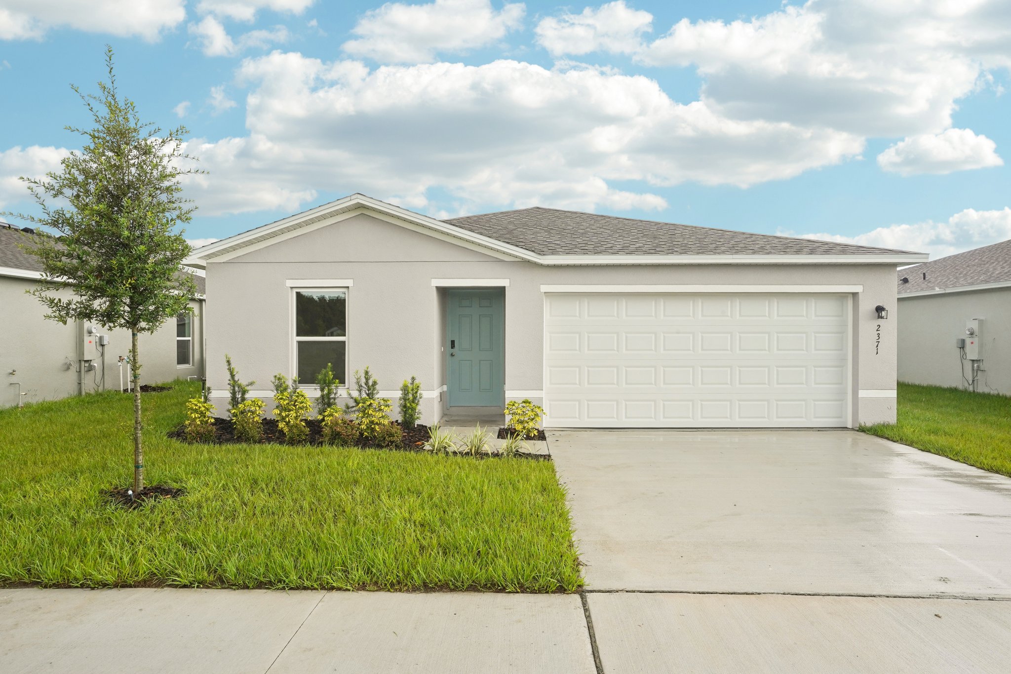 A white house with a garage.
