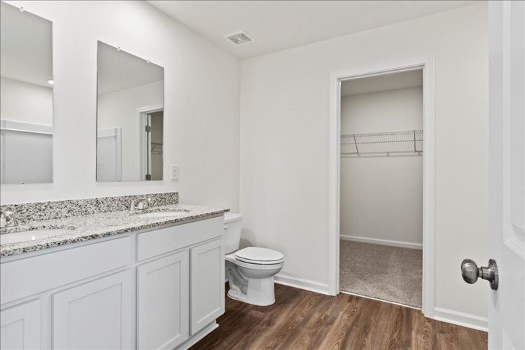 A bathroom with a toilet and sink.