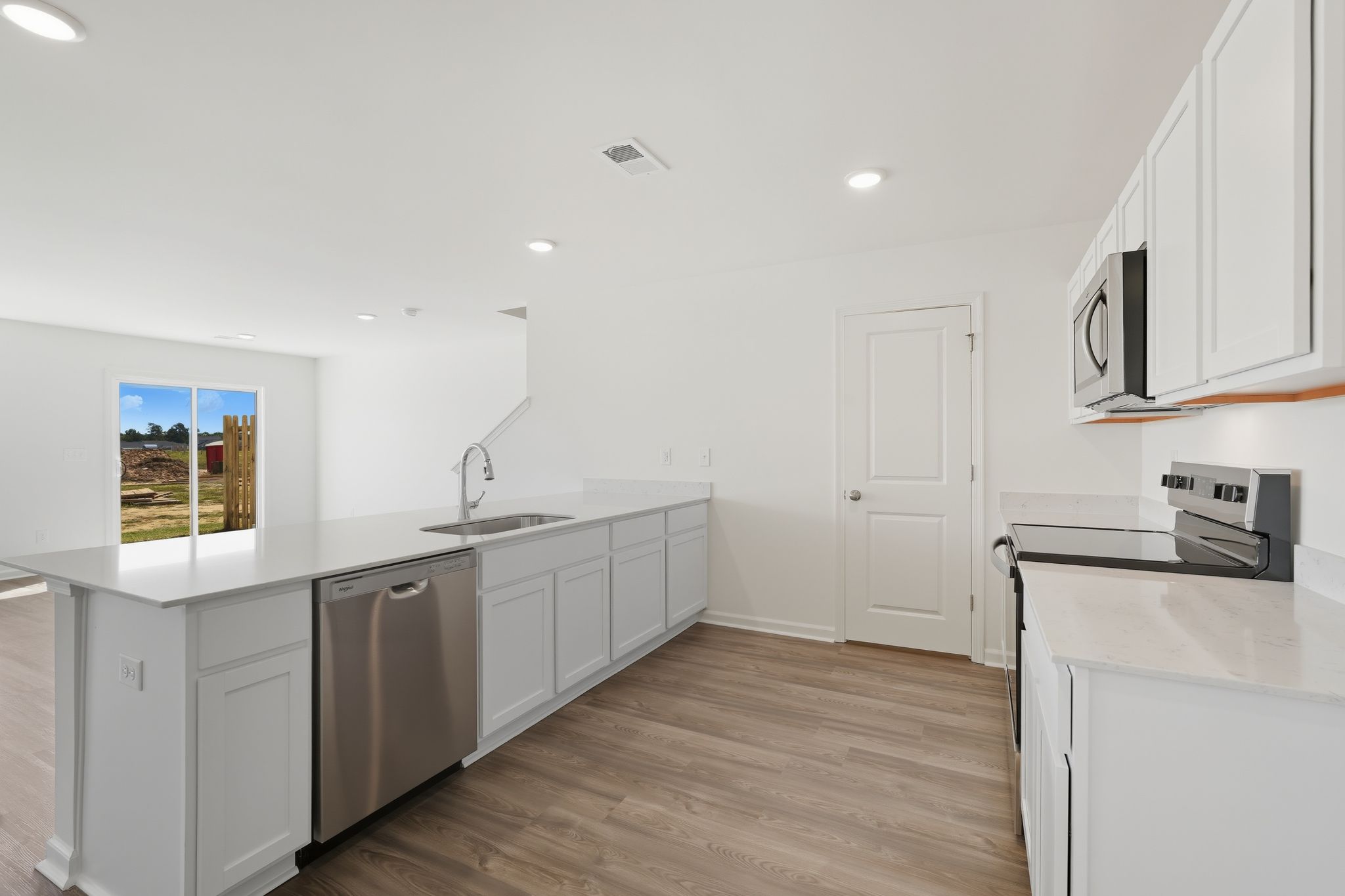 A kitchen with white cabinets.