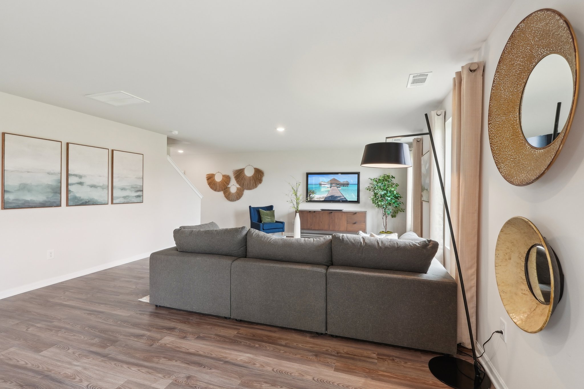 A living room with a large mirror.