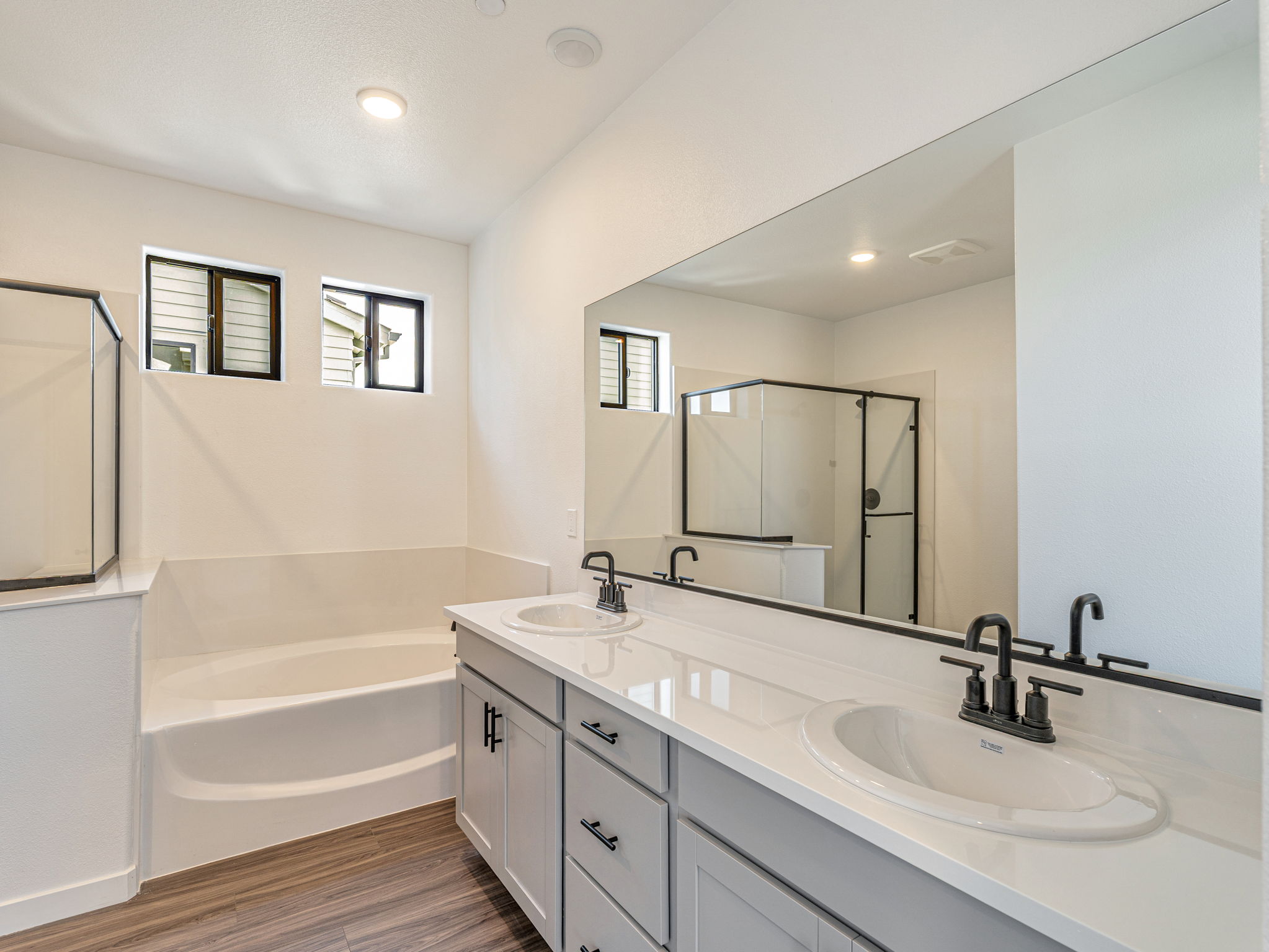 A bathroom with a large mirror.