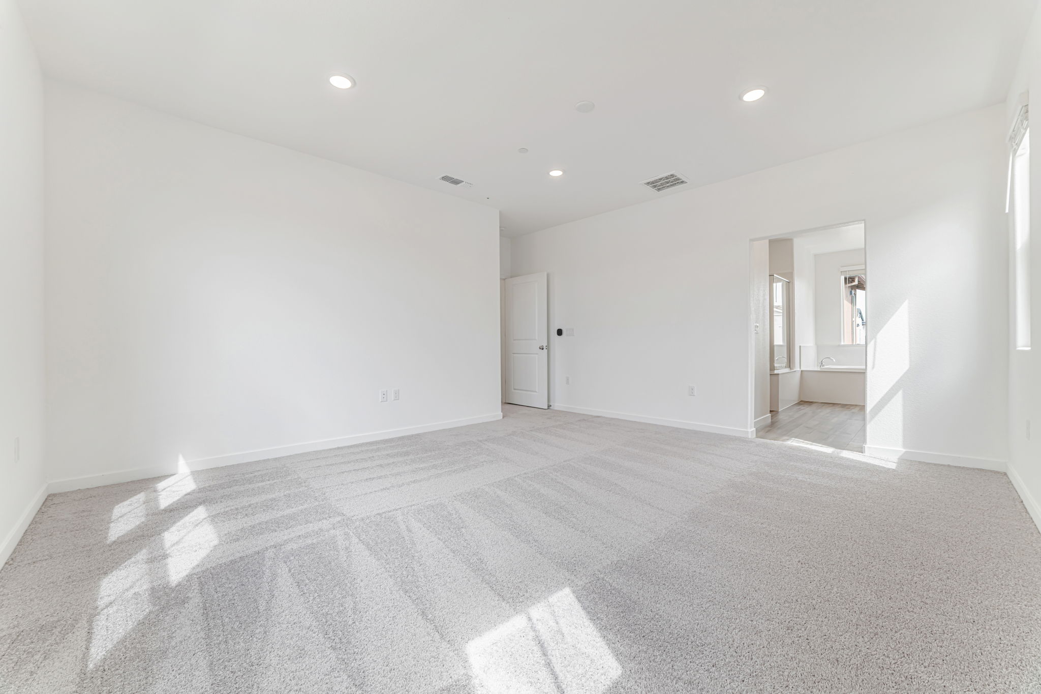 A hallway with white walls.