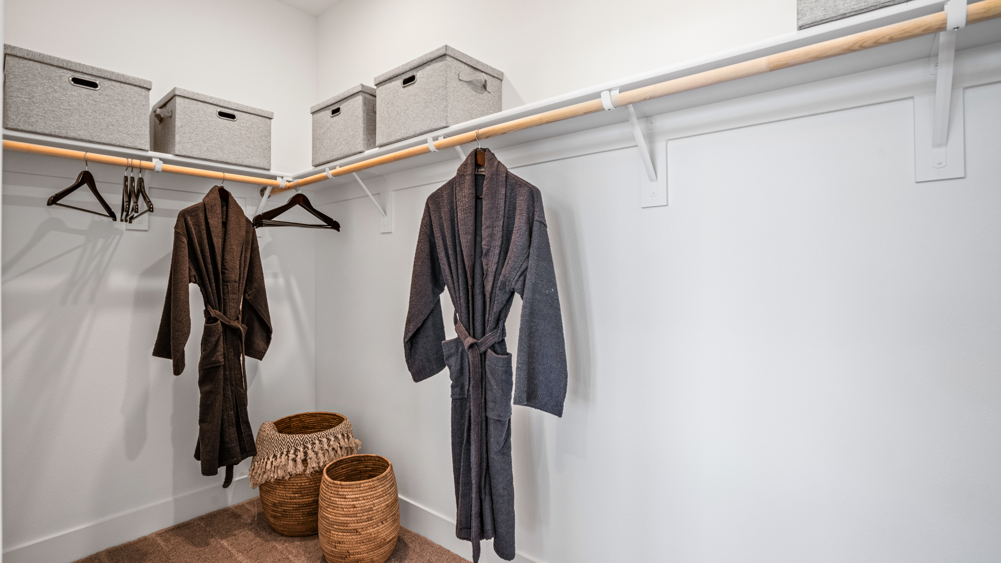 A room with clothes on the wall.