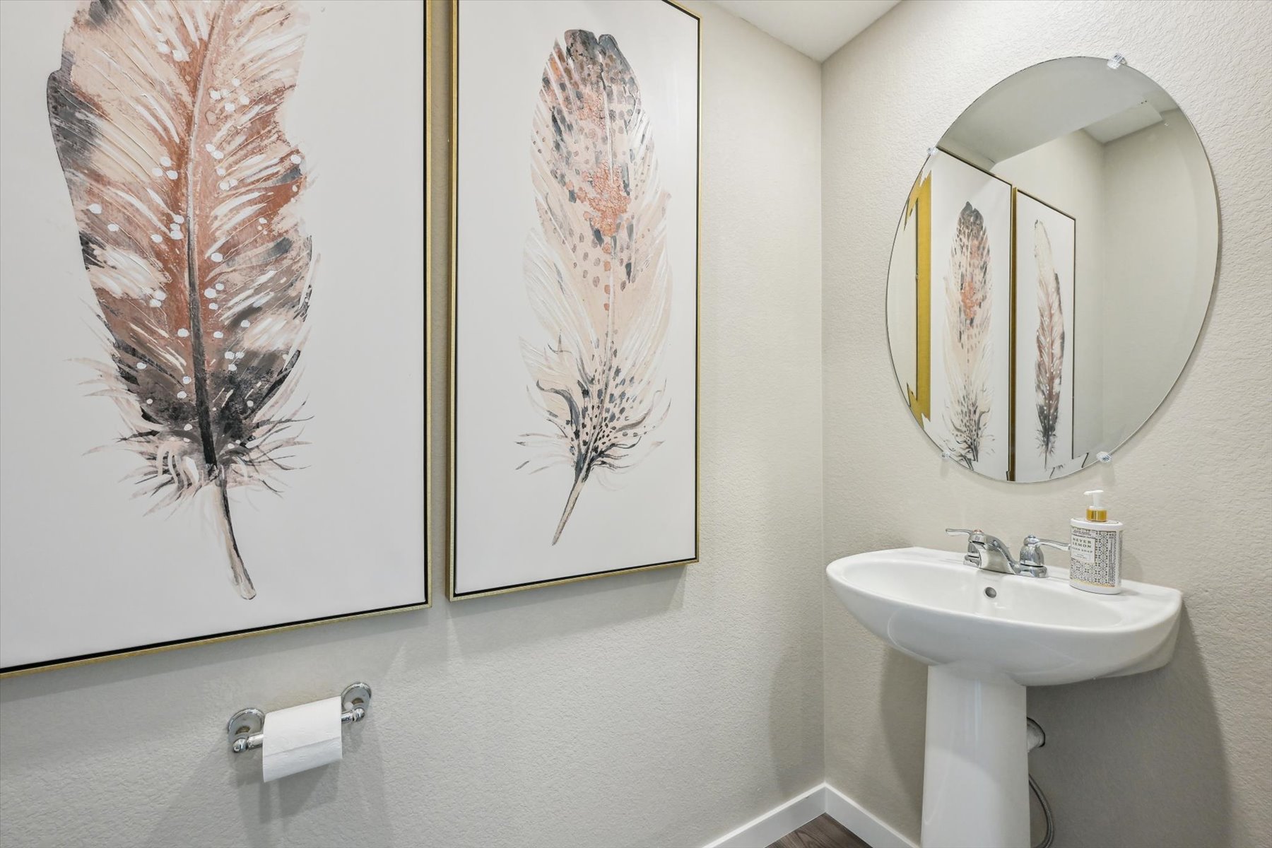 A bathroom with a mirror and a sink.
